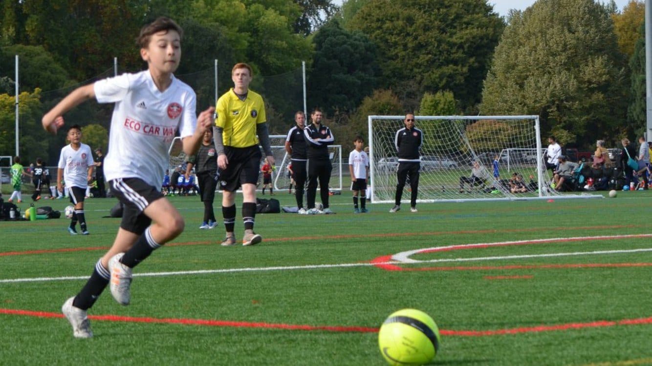 A soccer player chasing the ball during a game